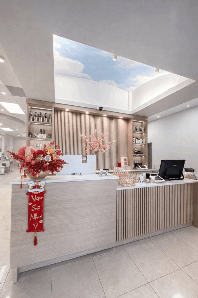 Salon reception desk with wood paneling and floral decorations